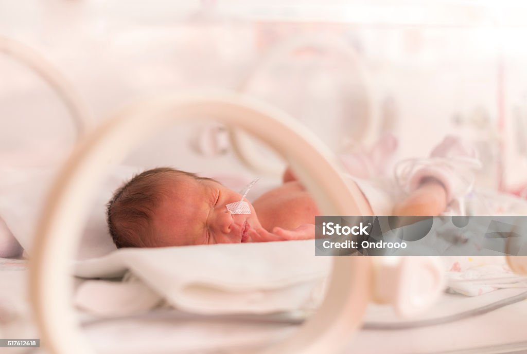 Newborn in NICU with nasal cannula, highlighting pregnancy complications care.