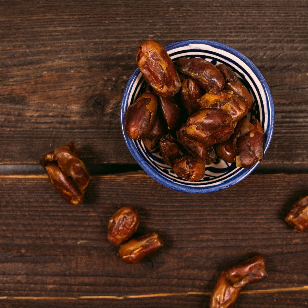 Rustic Ramadan preparation scene with ripe and unripe dates in a traditional bowl