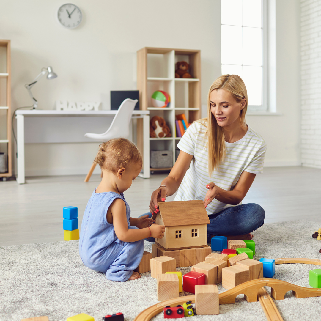 Woman and child building with blocks in playroom with smart home devices.