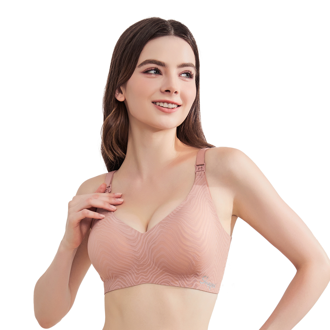 Woman wearing pink sports bra with wavy pattern and wireless earbuds