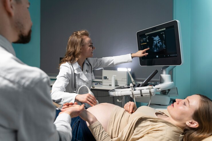 Pregnant woman receiving ultrasound; Mom Safety Tips in a calm blue room.