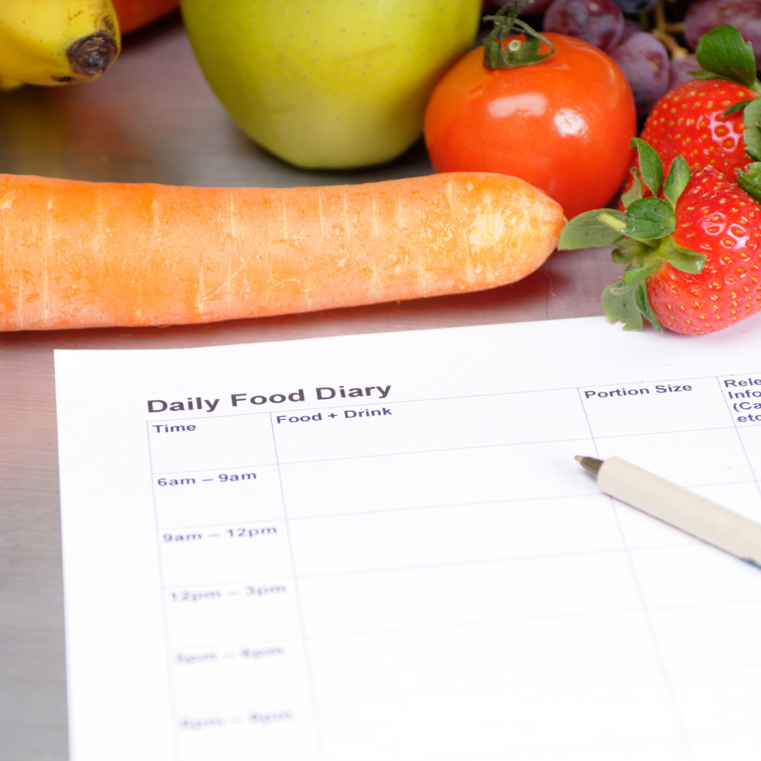 Table with fruits like banana, apple, carrot; Daily Food Diary; pregnancy weight management.