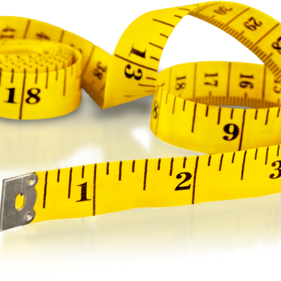 Coiled yellow measuring tape on white surface with clear contrasting numbers