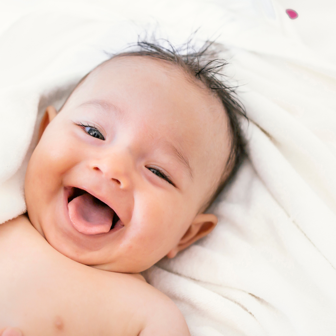 Baby smiling with bright eyes, exploring surroundings with a sense of wonder