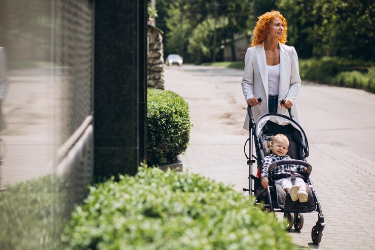 Woman with stroller and child strolls city sidewalk, evokes mental health improvement