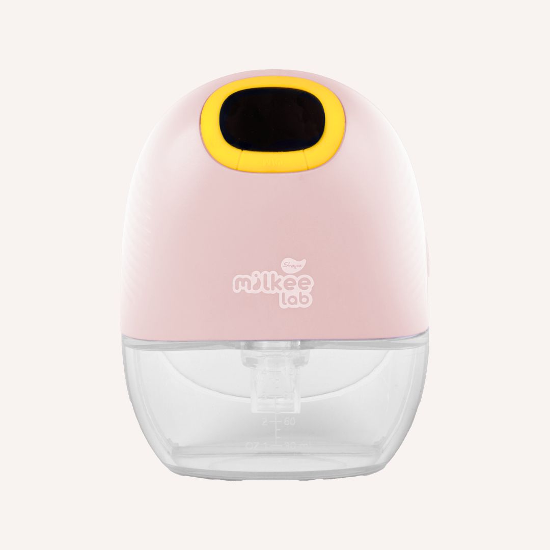 Milk Lab pink and yellow Hands-Free Breast Pump with clear storage container