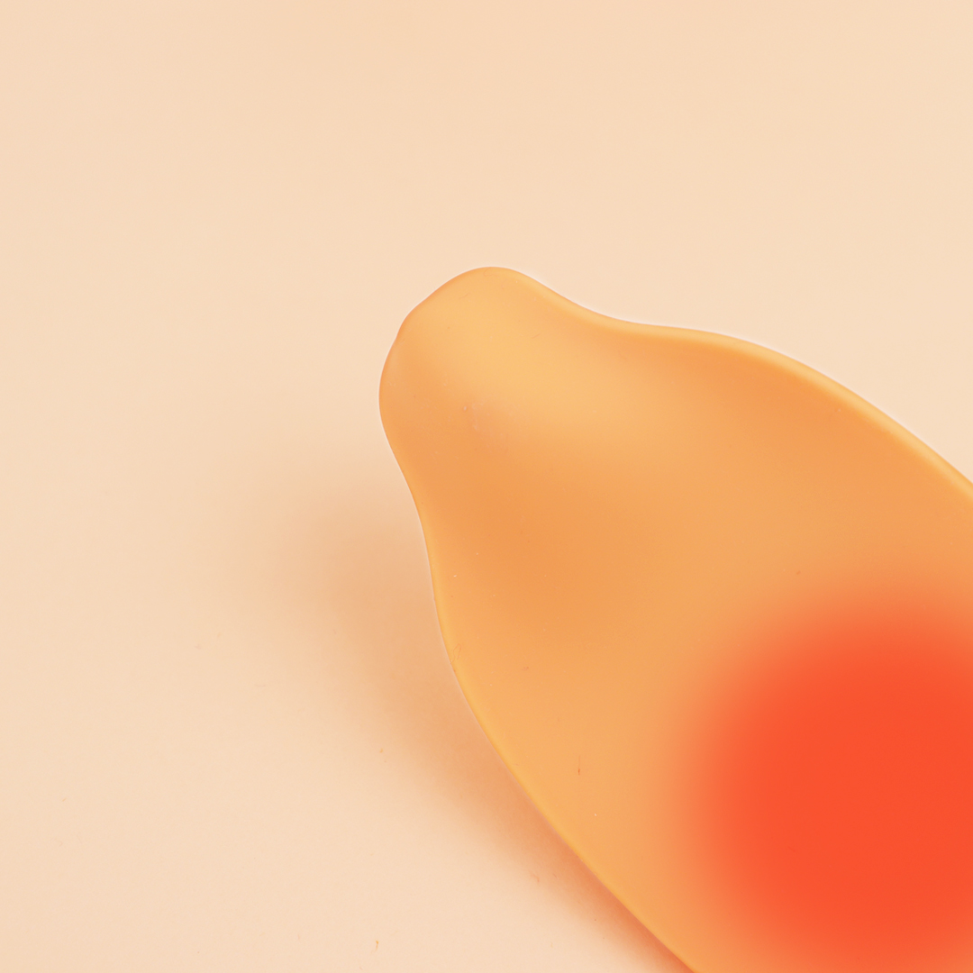 Vibrant ripe mango against a soft peach background, highlighting juiciness